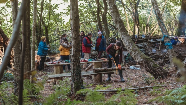 A group of people at a woodland activity session