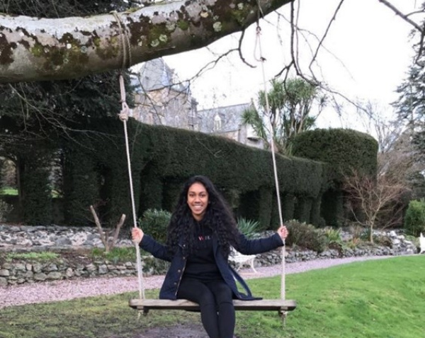 Woman sitting on a tree swing